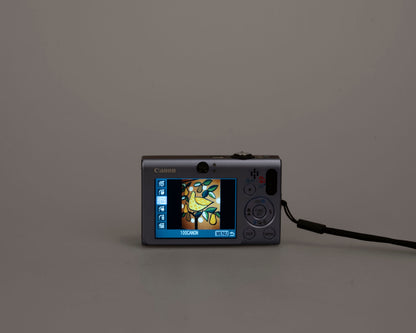 Canon Powershot SD1100 IS Digital Elph 8MP CCD digicam w/ 2GB SD card + batteries + charger + original box + case