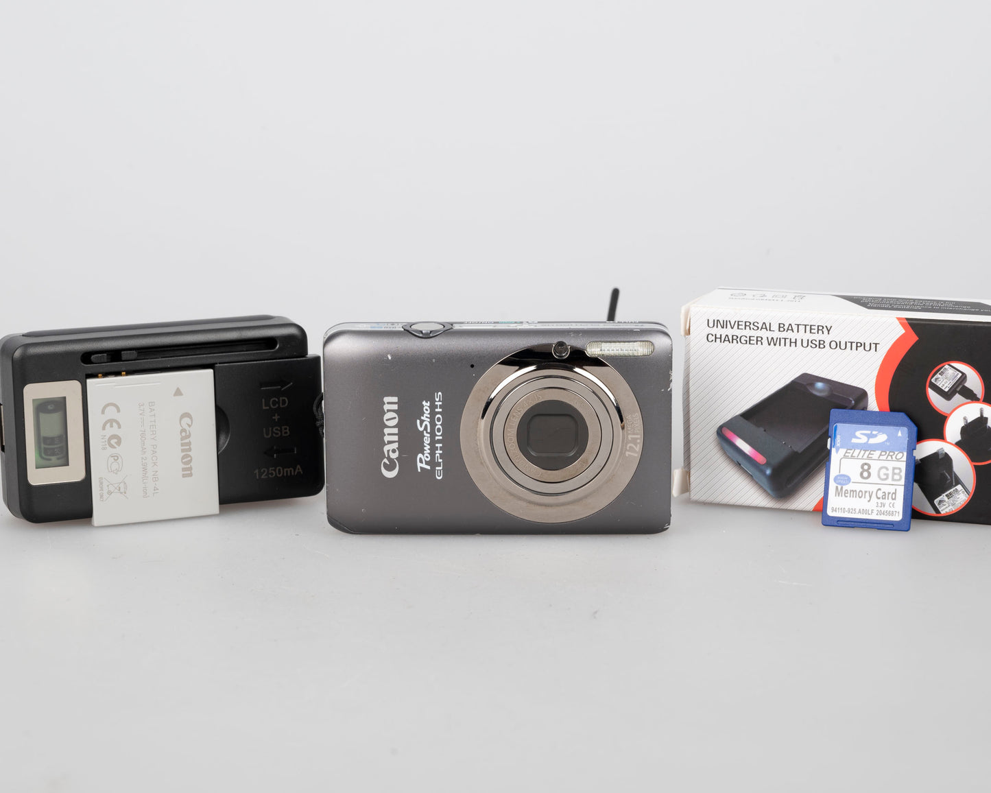 Canon Powershot Digital Elph 100 HS 12.1MP digicam w/ 8GB SD card + battery + charger