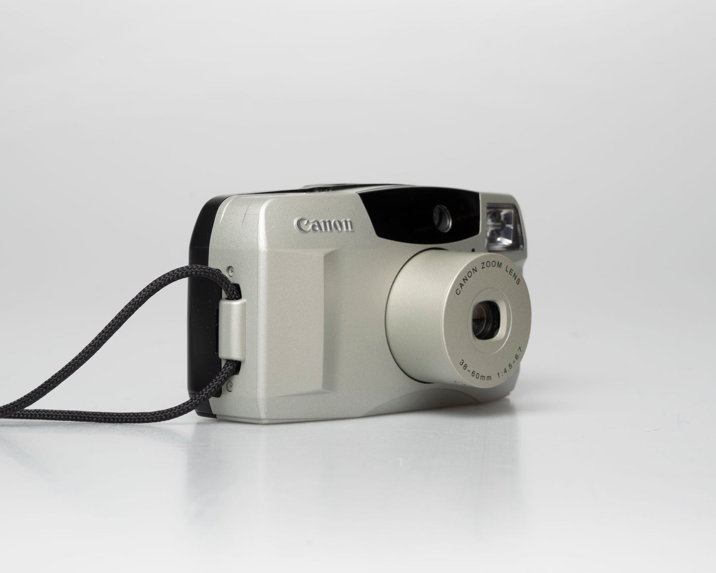 Canon Sure Shot 60 Zoom 35mm point-and-shoot camera; left angle zoomed out