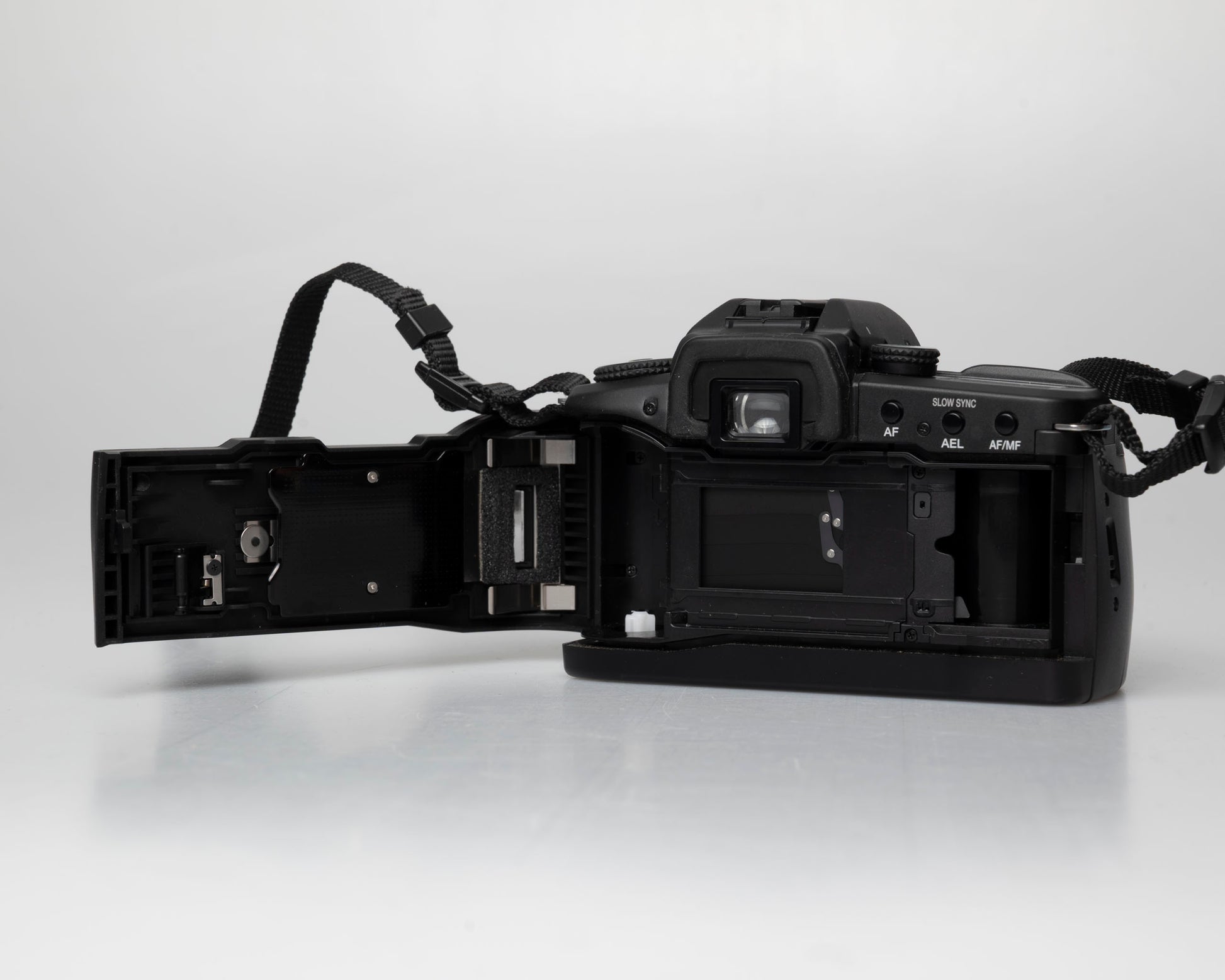 Minolta Maxxum 70 35mm film camera with 50mm f1.7 lens; back view with film door open