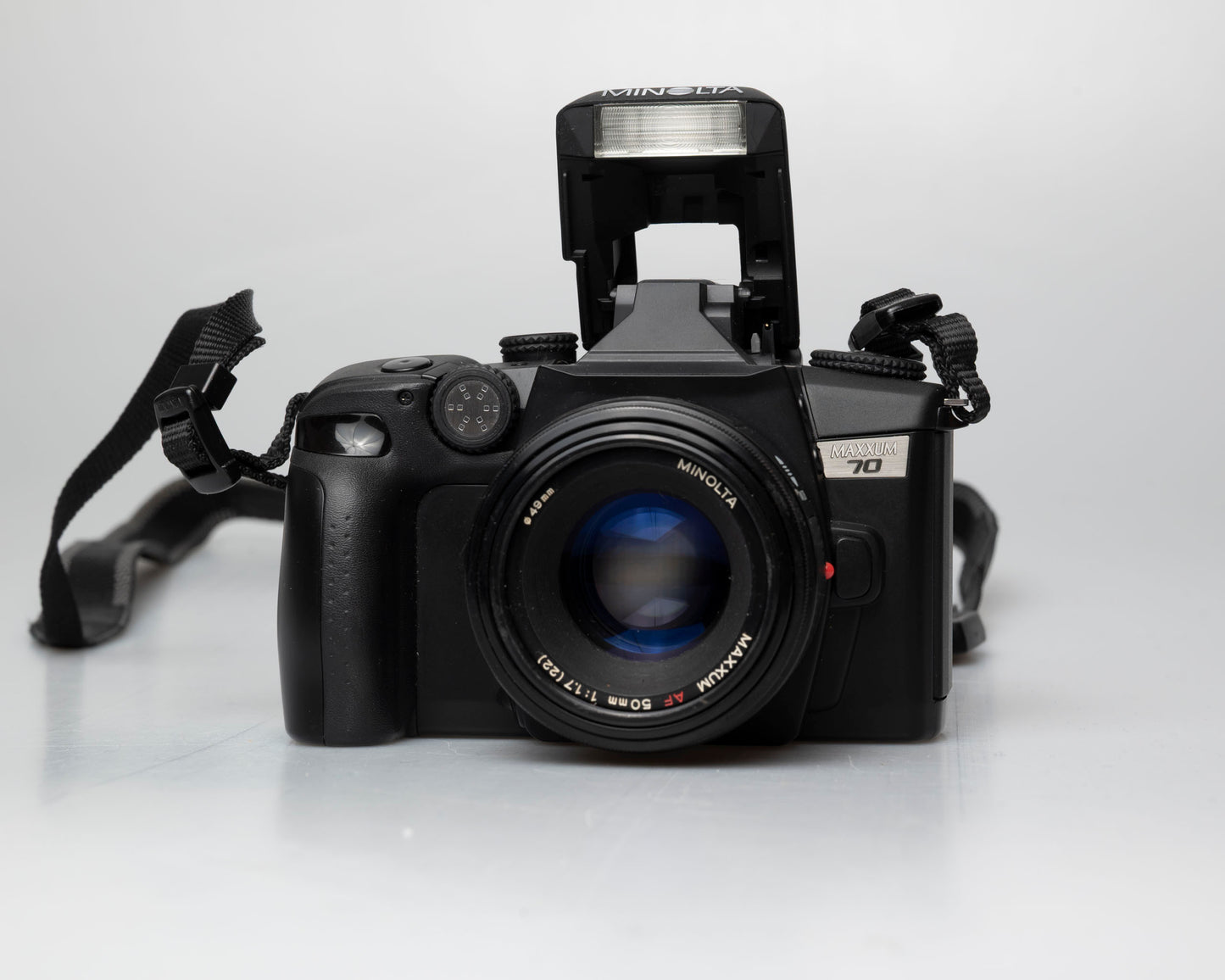 Minolta Maxxum 70 35mm film camera with 50mm f1.7 lens; front view with pop-up flash showing
