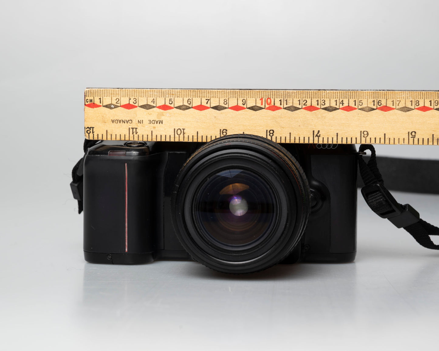Nikon N6000 35mm film camera; front view with ruler for scale