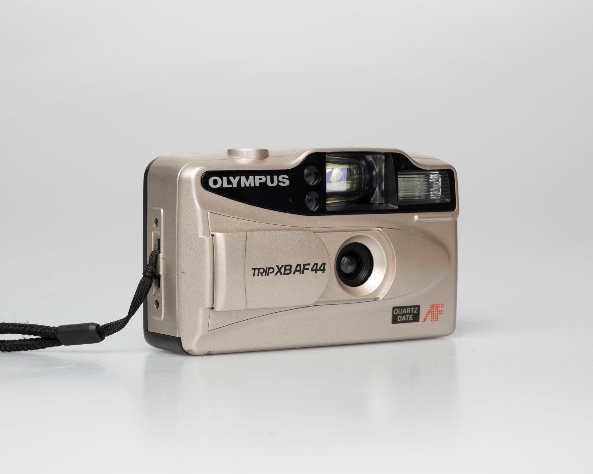 Olympus Trip XB AF44 compact 35mm film point-and-shoot camera; left angle view lens cover open