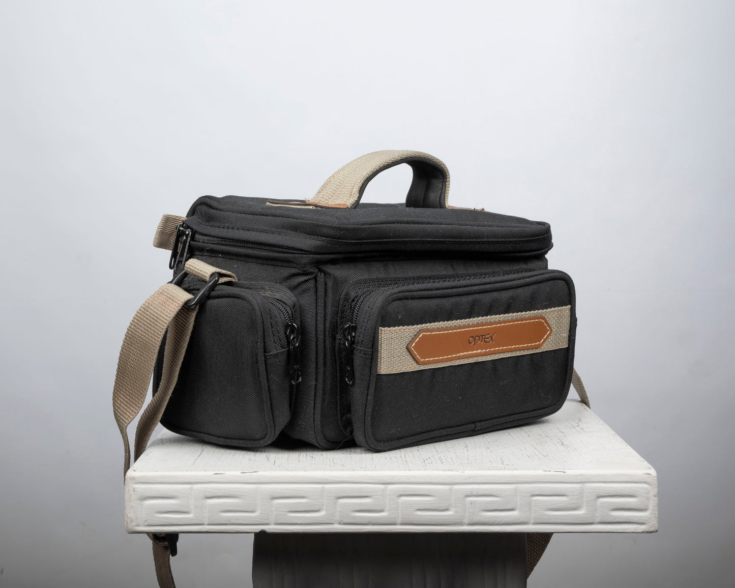Optex mid-sized black and tan camera bag