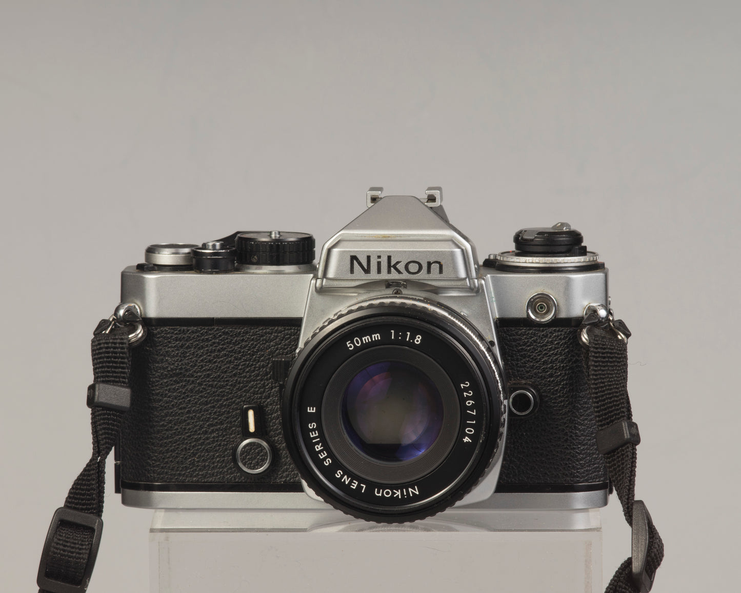 Nikon FE 35mm film SLR camera with Nikon E 50mm f1.8 lens. Available at New Wave Pool, Montreal.