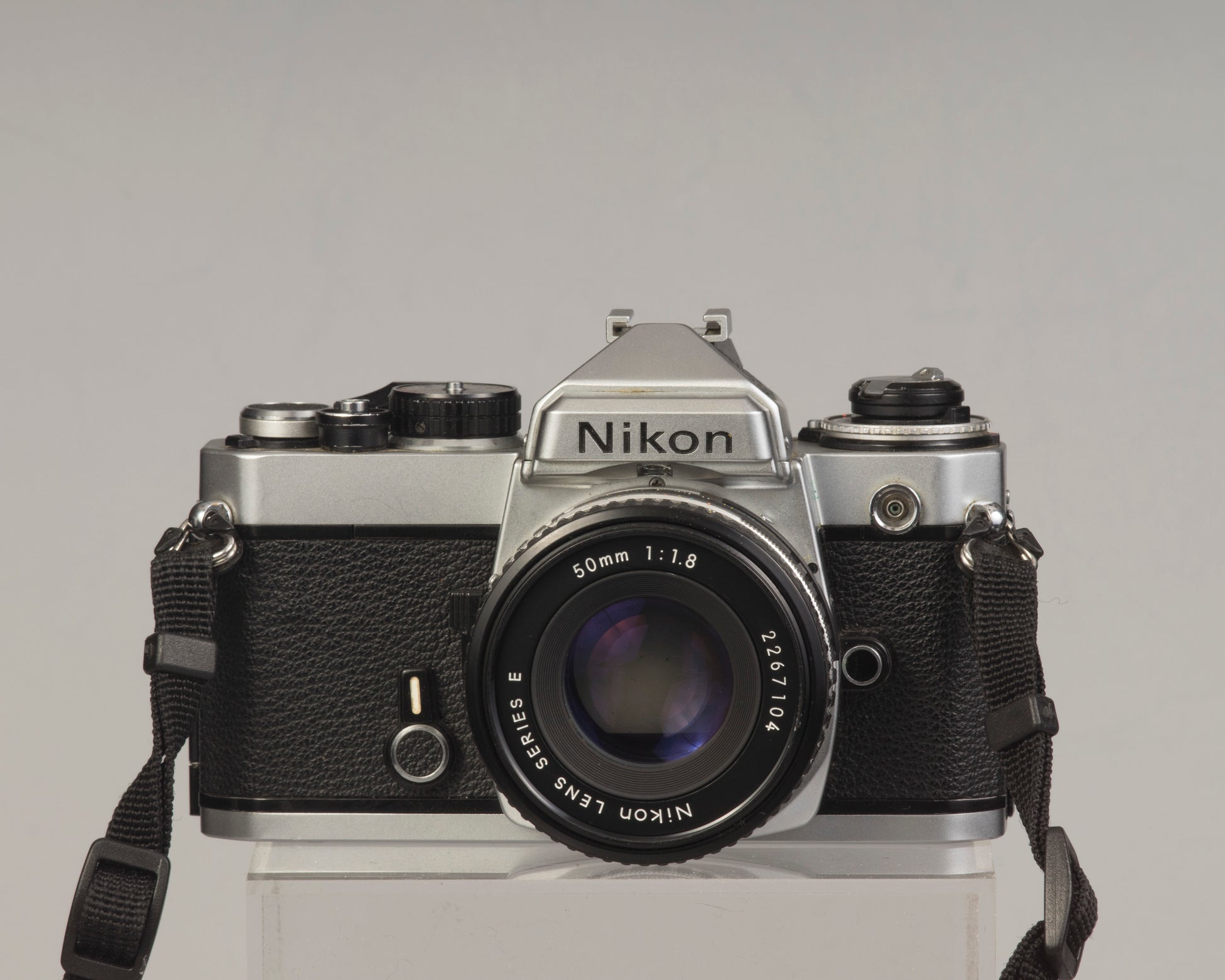 Nikon FE 35mm film SLR camera with Nikon E 50mm f1.8 lens. Available at New Wave Pool, Montreal.