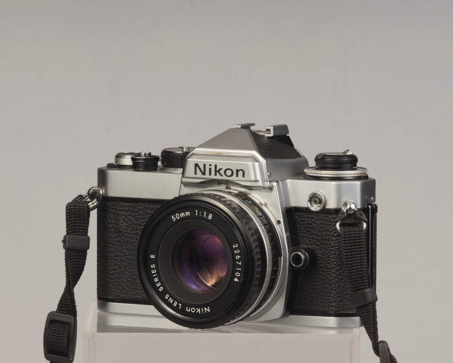 Nikon FE 35mm film SLR camera with Nikon E 50mm f1.8 lens. Available at New Wave Pool, Montreal.