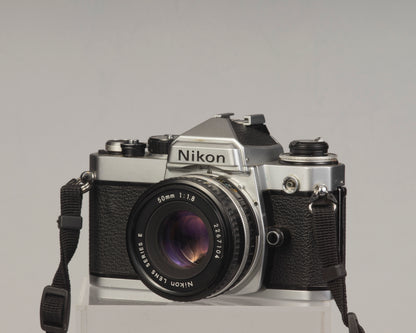 Nikon FE 35mm film SLR camera with Nikon E 50mm f1.8 lens. Available at New Wave Pool, Montreal.