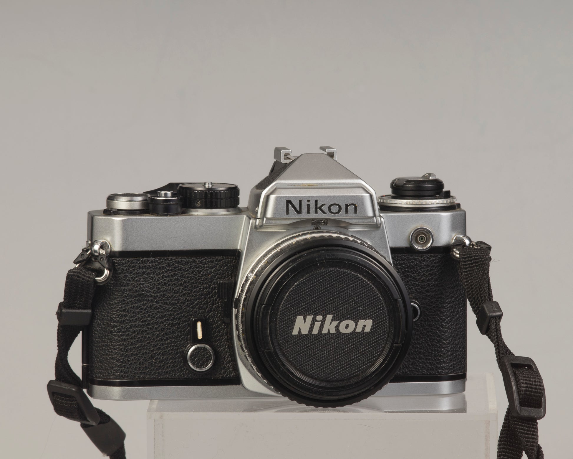 Nikon FE 35mm film SLR camera with Nikon E 50mm f1.8 lens. Available at New Wave Pool, Montreal.
