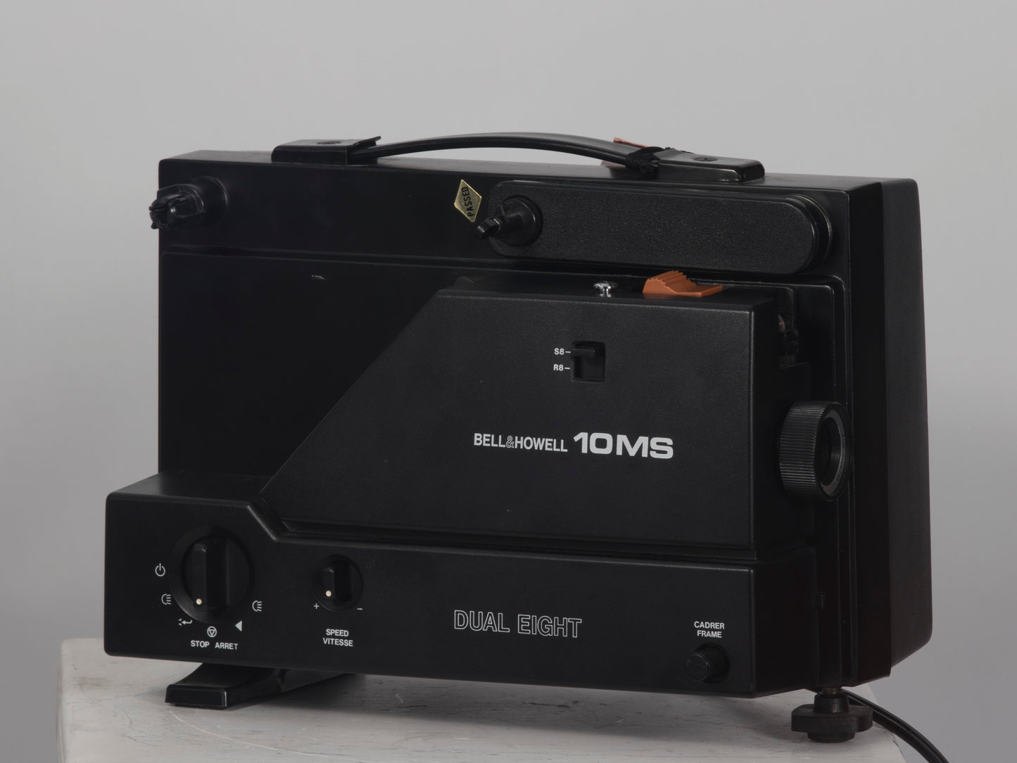 Bell and Howell 10MS dual 8mm & Super 8 projector. Shown with takeup reel. Angled view.