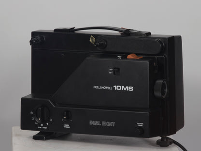 Bell and Howell 10MS dual 8mm & Super 8 projector. Shown with takeup reel. Angled view.