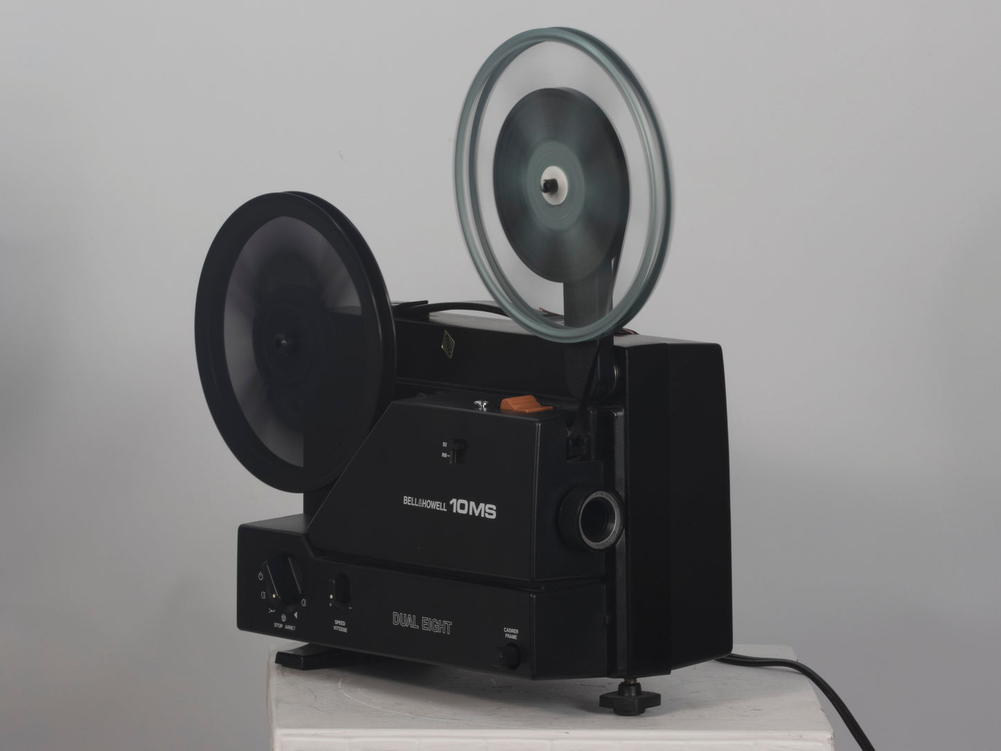 Bell and Howell 10MS dual 8mm & Super 8 projector. Angled view, shown operating.