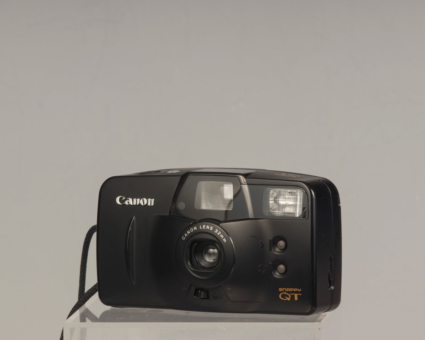 The Canon Snappy QT is a 35mm film point-and-shoot camera featuring a 32mm lens and an unusually large and bright viewfinder.