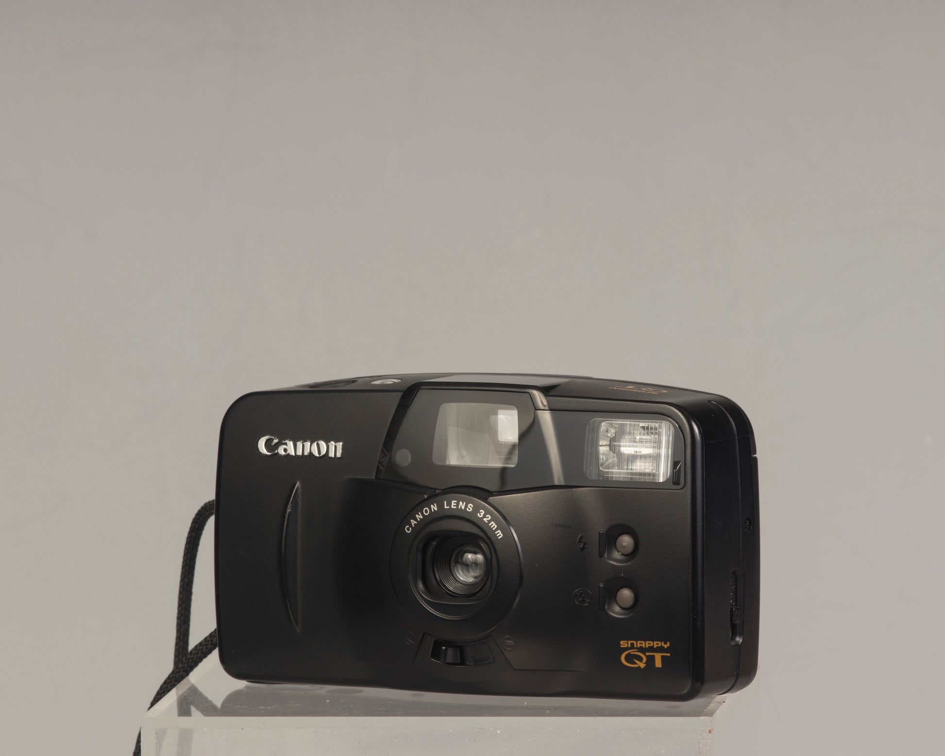 The Canon Snappy QT is a 35mm film point-and-shoot camera featuring a 32mm lens and an unusually large and bright viewfinder.