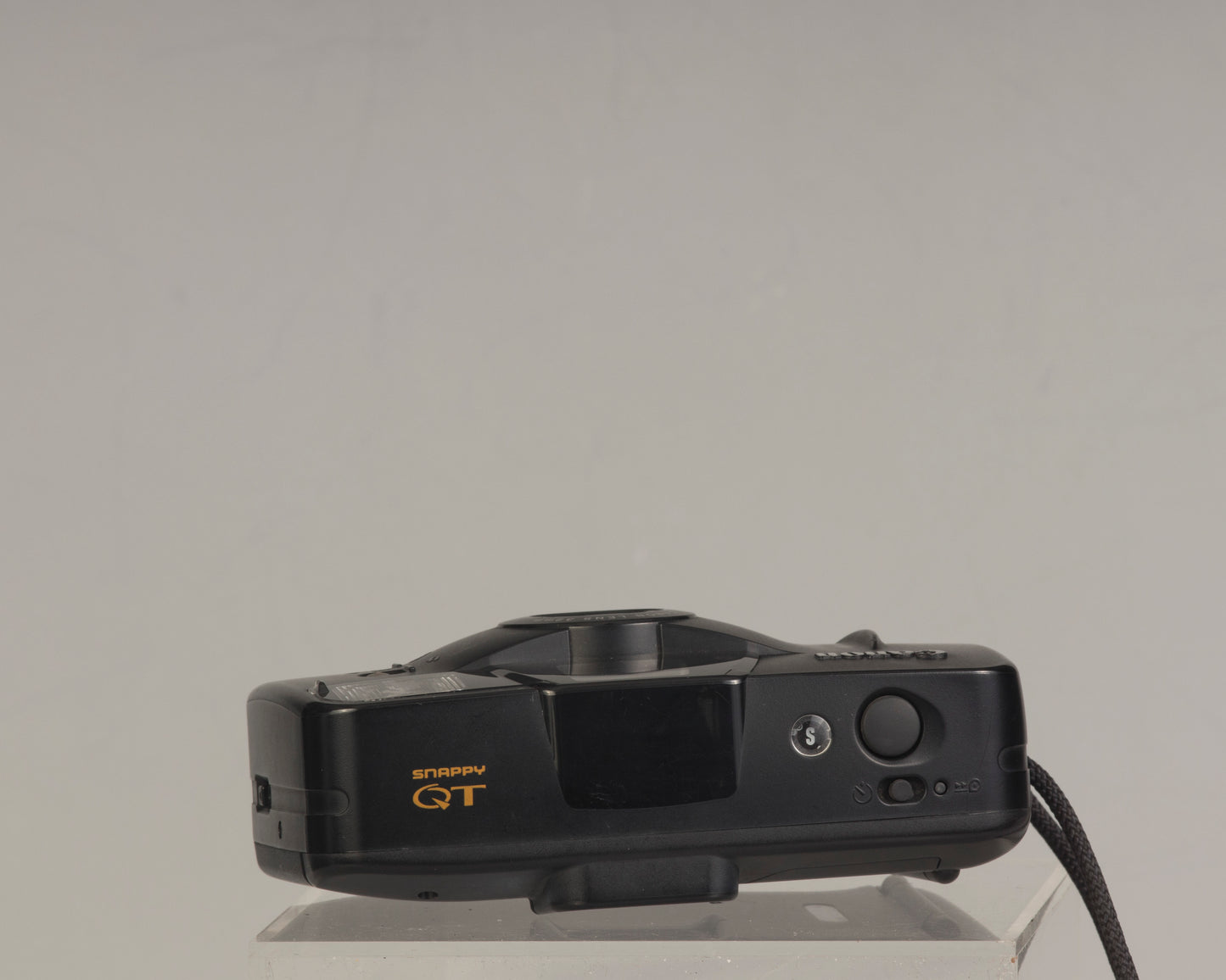 The Canon Snappy QT is a 35mm film point-and-shoot camera featuring a 32mm lens and an unusually large and bright viewfinder.