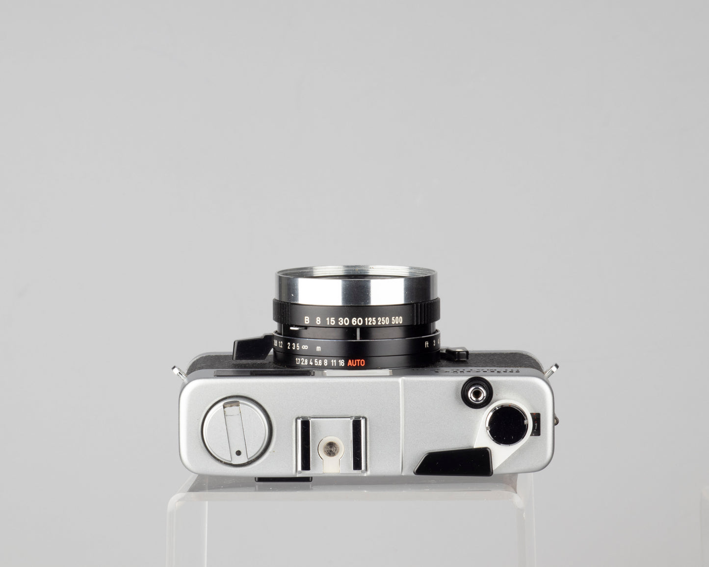 Minolta Hi-Matic 7SII 35mm rangefinder camera with half-case and Minolta 20 flash