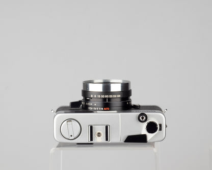Minolta Hi-Matic 7SII 35mm rangefinder camera with half-case and Minolta 20 flash