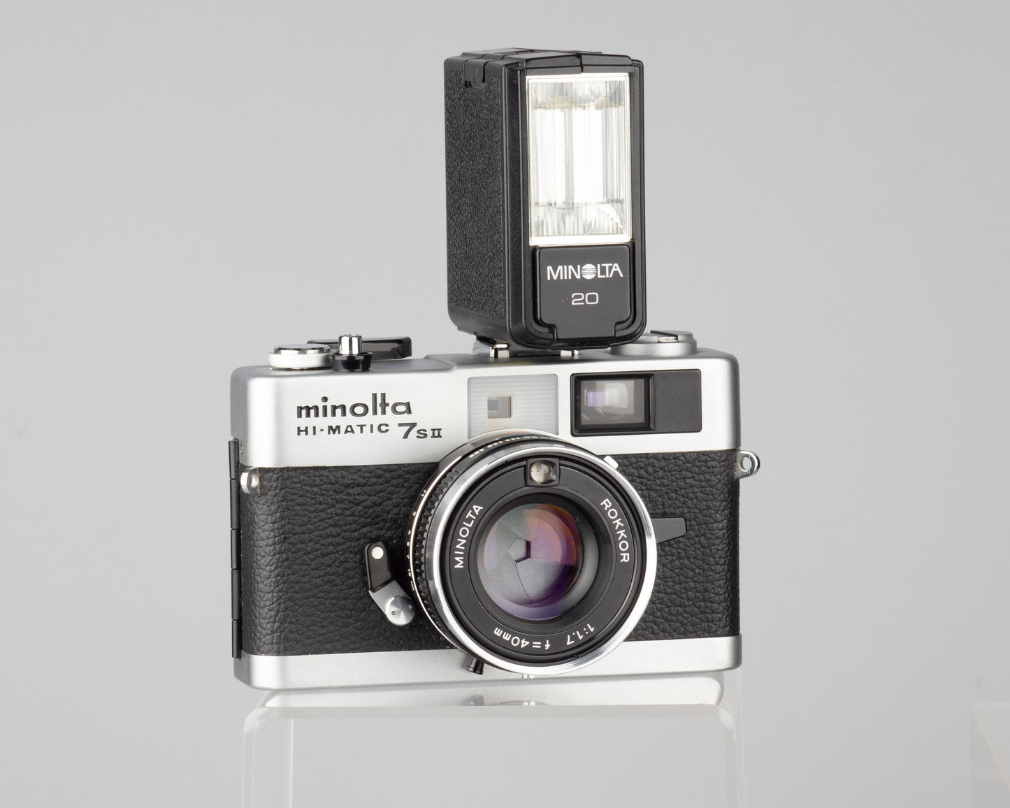Minolta Hi-Matic 7SII 35mm rangefinder camera with half-case and Minolta 20 flash