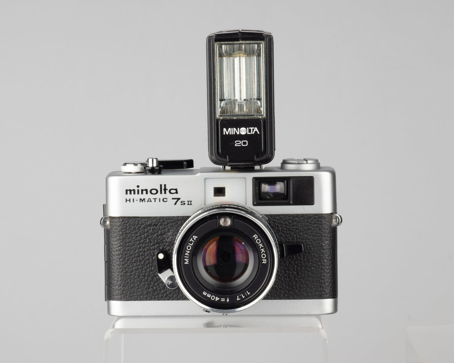 Minolta Hi-Matic 7SII 35mm rangefinder camera with half-case and Minolta 20 flash