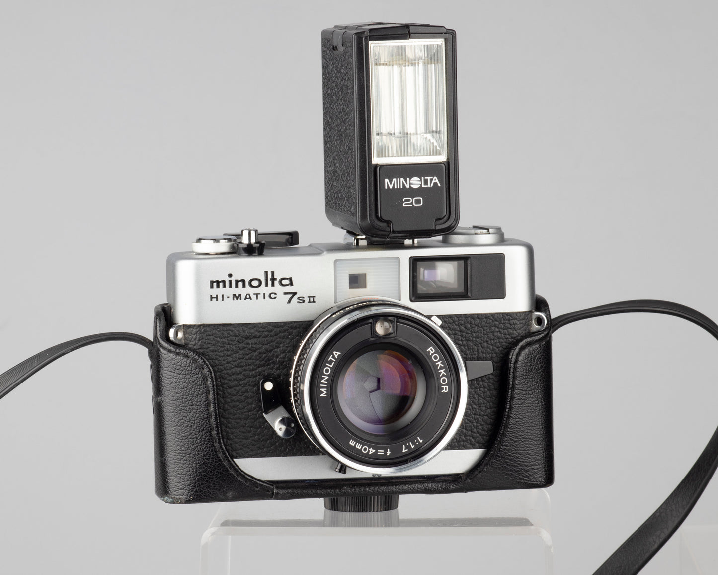 Minolta Hi-Matic 7SII 35mm rangefinder camera with half-case and Minolta 20 flash
