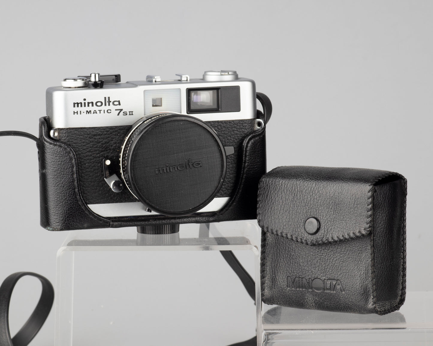 Minolta Hi-Matic 7SII 35mm rangefinder camera with half-case and Minolta 20 flash