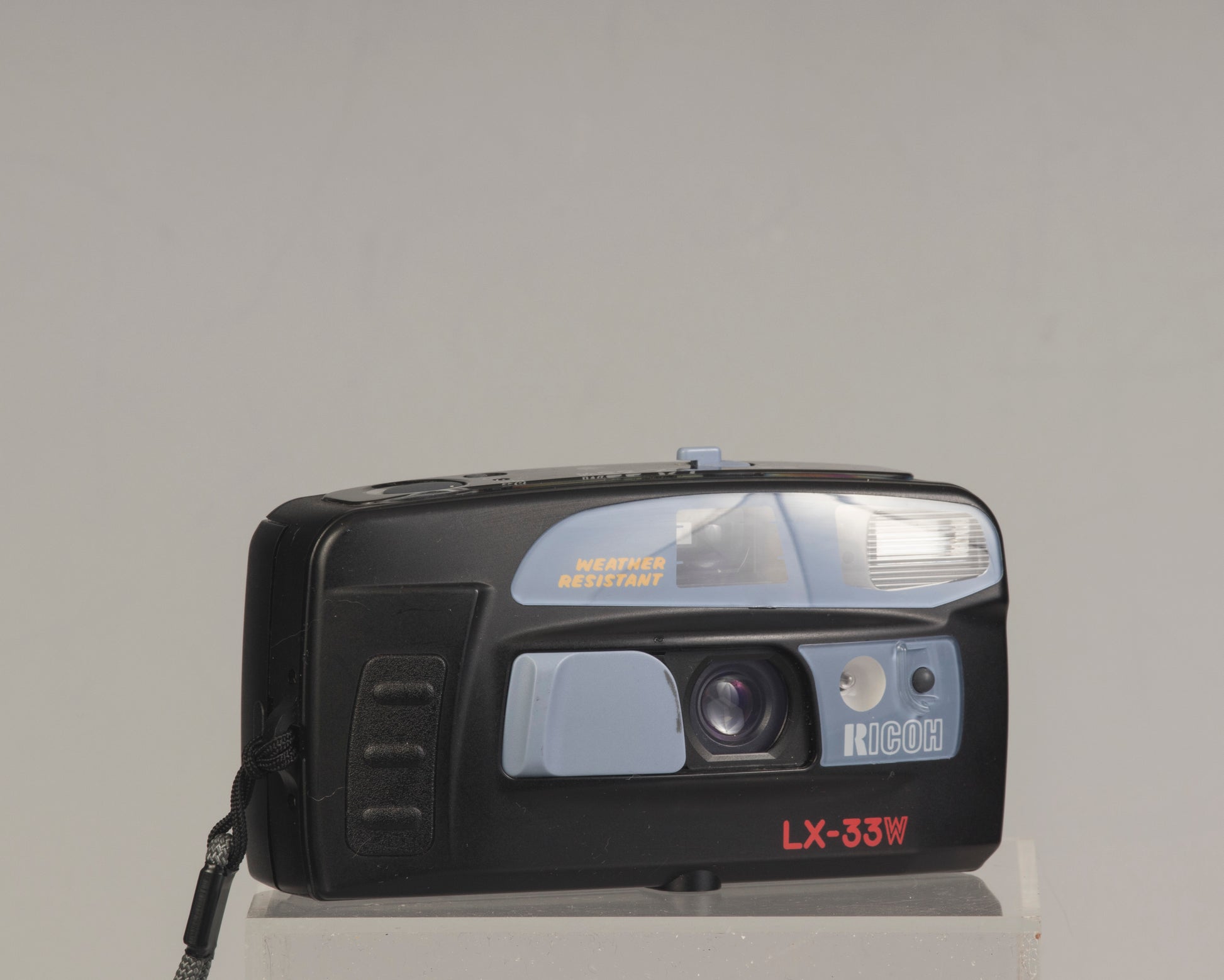 The Ricoh LX-33W is a simple weather-resistant 35mm film point-and-shoot camera from the 1990s