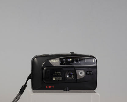 The Ricoh RW-1 Date is a 35mm film point-and-shoot camera from circa 1993. This camera features a 34mm lens and a weather resistant housing