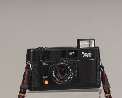 The Yashica Auto Focus Motor (shown with flash popped up) is a classic 35mm point-and-shoot film camera featuring a 38mm f2.8 lens