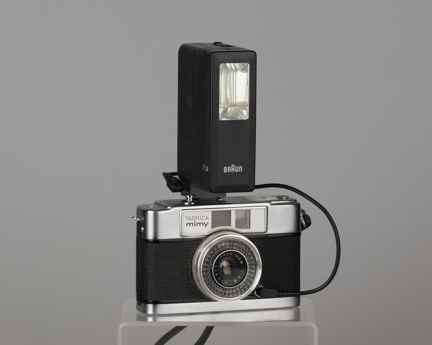 Yashica Mimy half-frame 35mm camera plus Braun flash